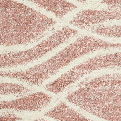 Cream and rose area rug with power loomed polypropylene pile in accent shape