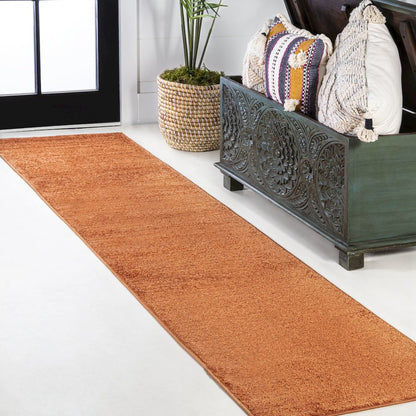 Haze Solid Low Pile Area Rug Orange