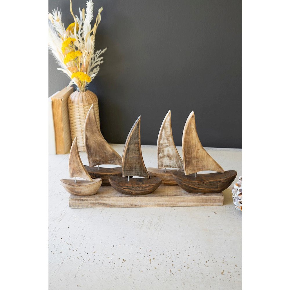 Five Wooden Sail Boats On A Base