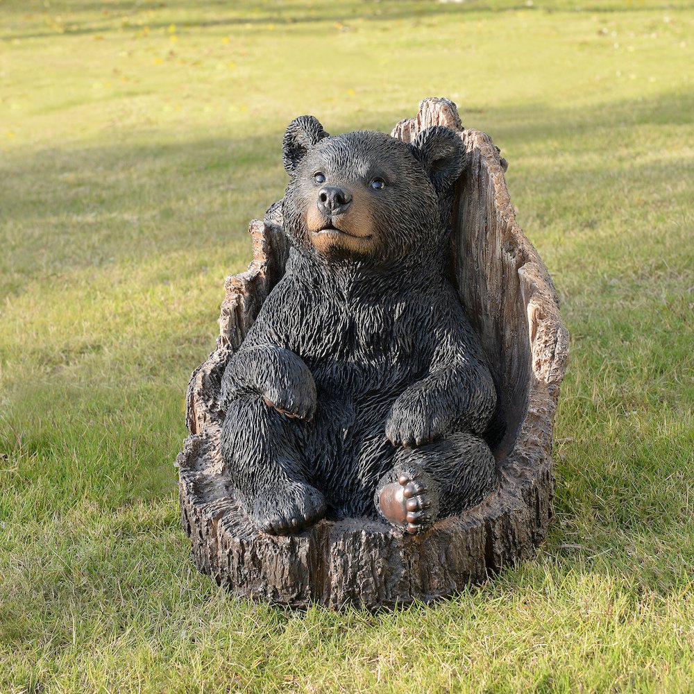 Lone Cub Haven: Intriguing Black Polyresin Bear in Stump Figurine